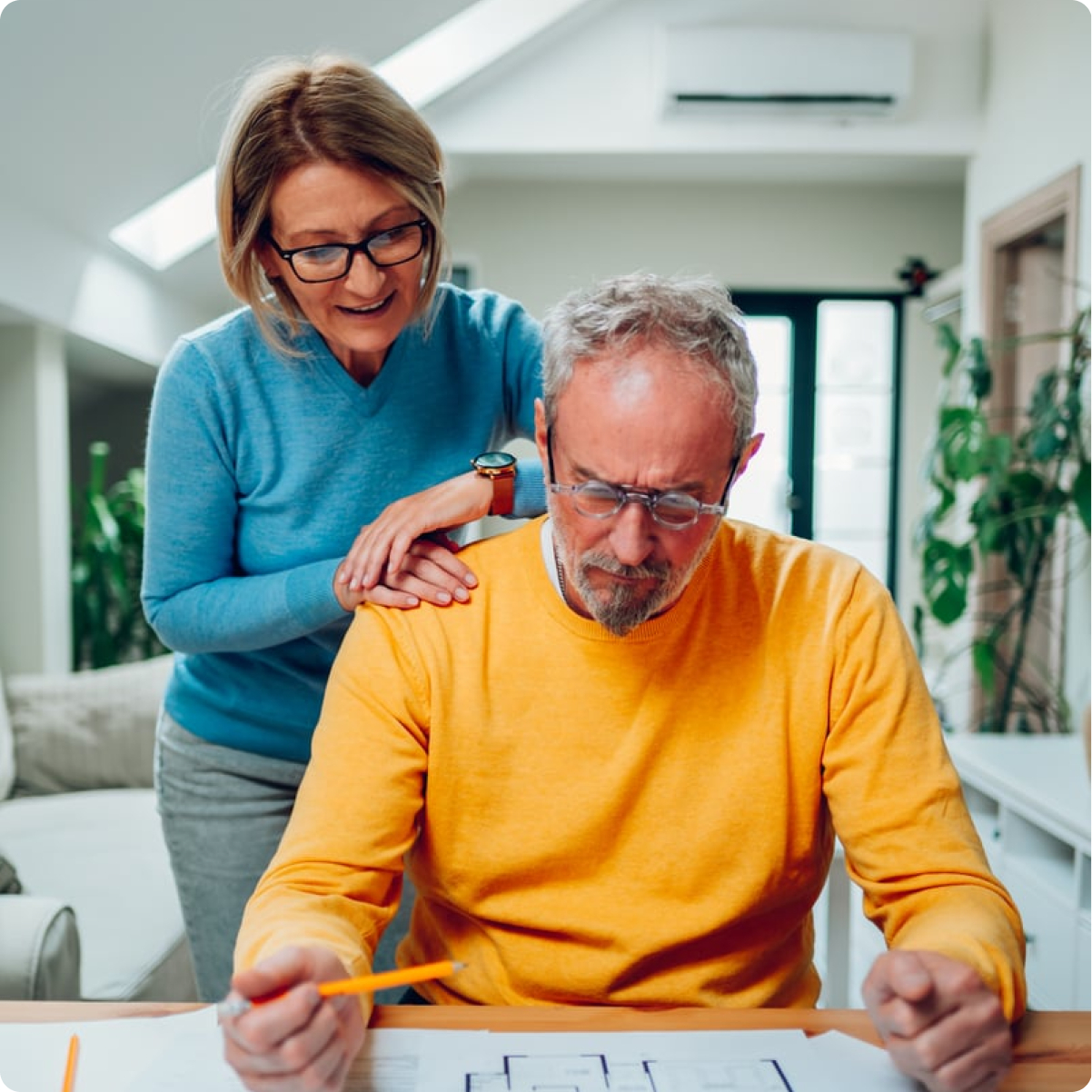 An older couple looking over plans at home