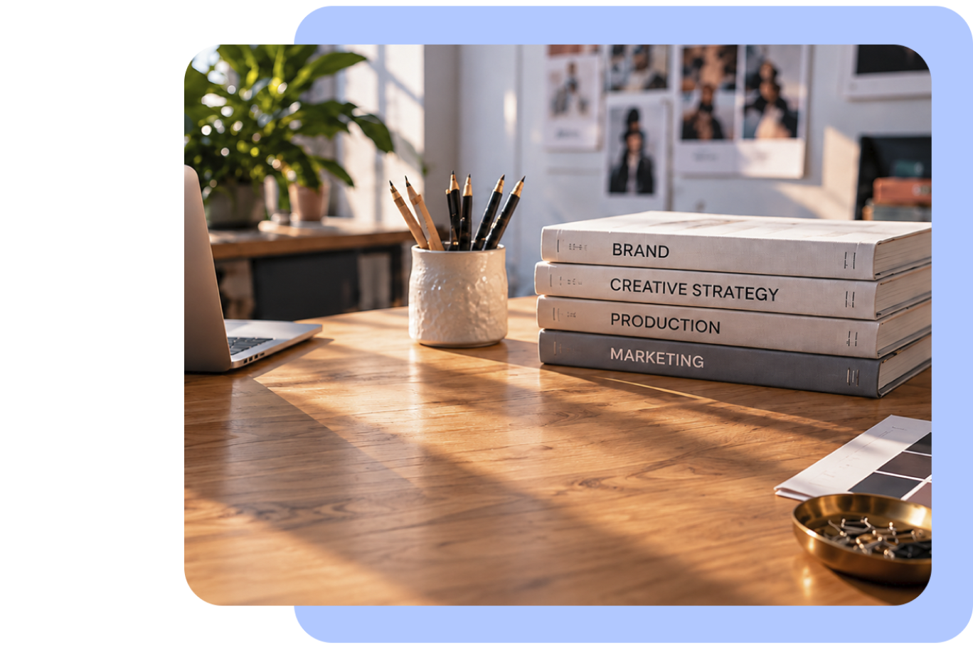Creative strategy books on a sunlit studio desk