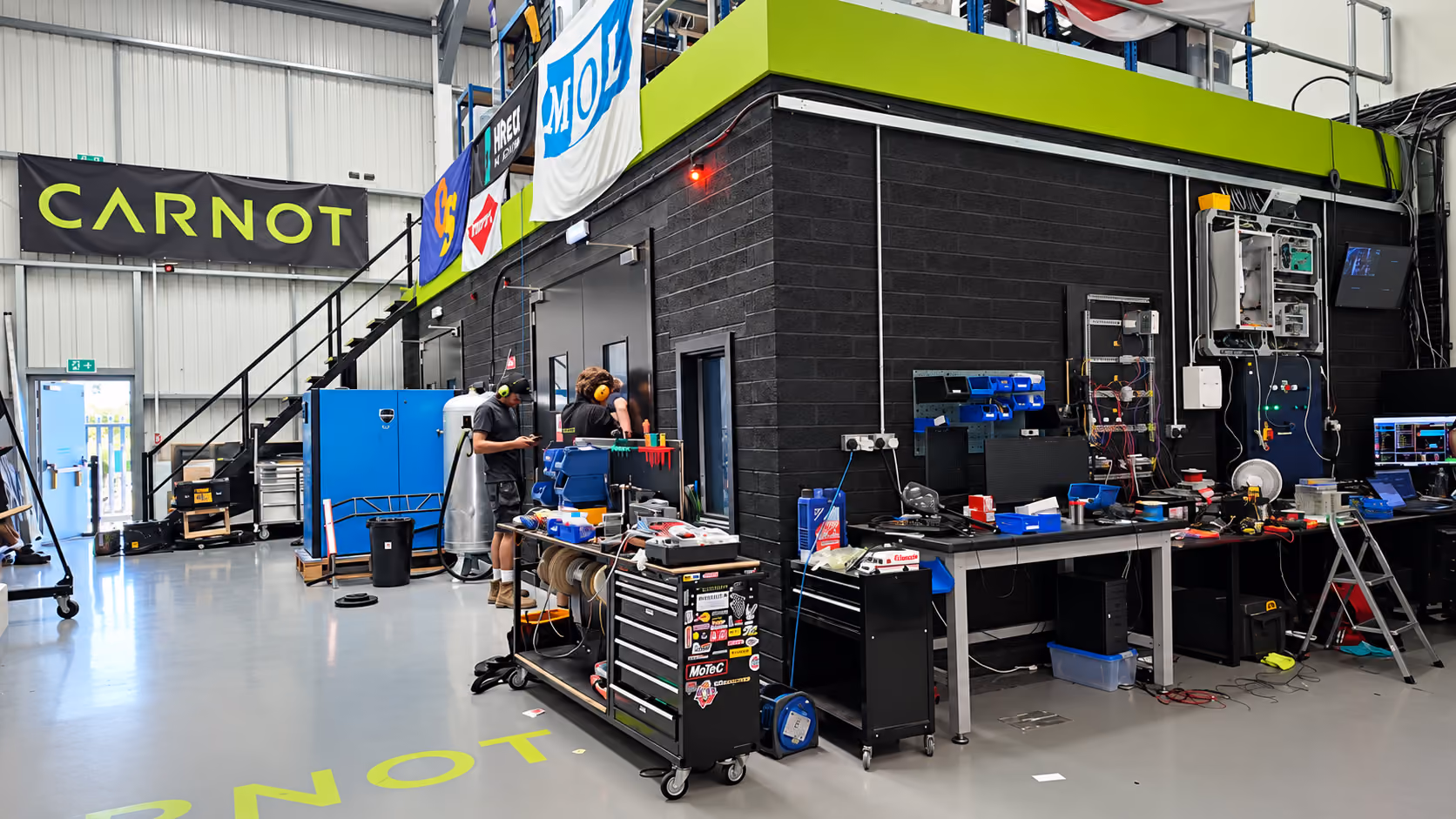 Carnot engineering workshop with technicians and test equipment