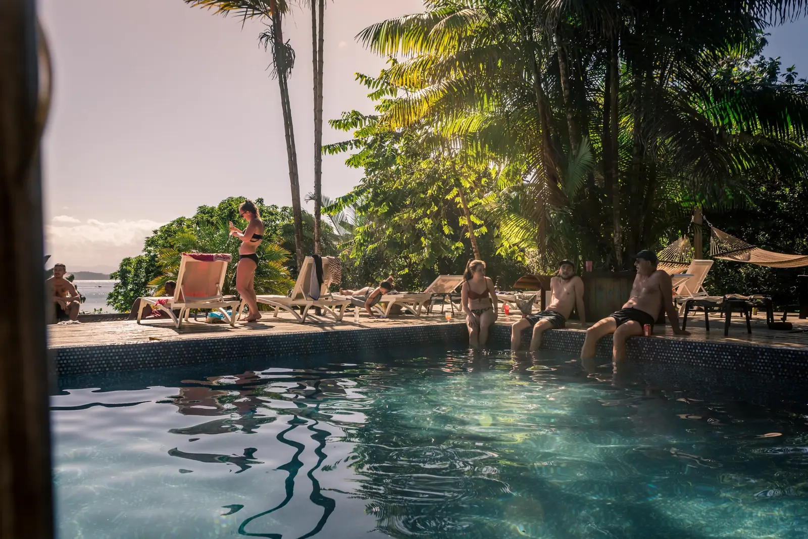Guests relaxing by the pool at Bambuda Lodge