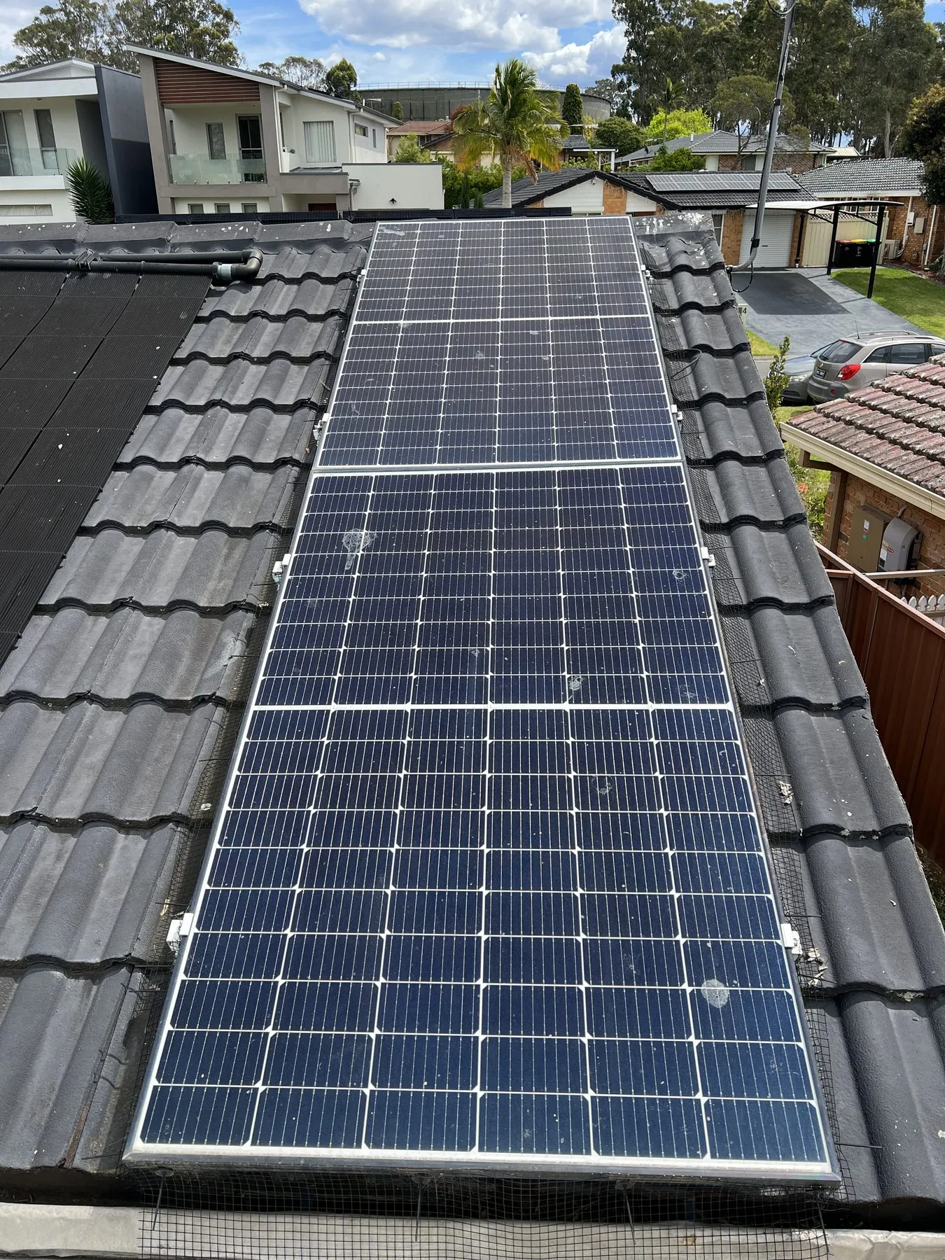 Solar panels with visible surface deposits before cleaning