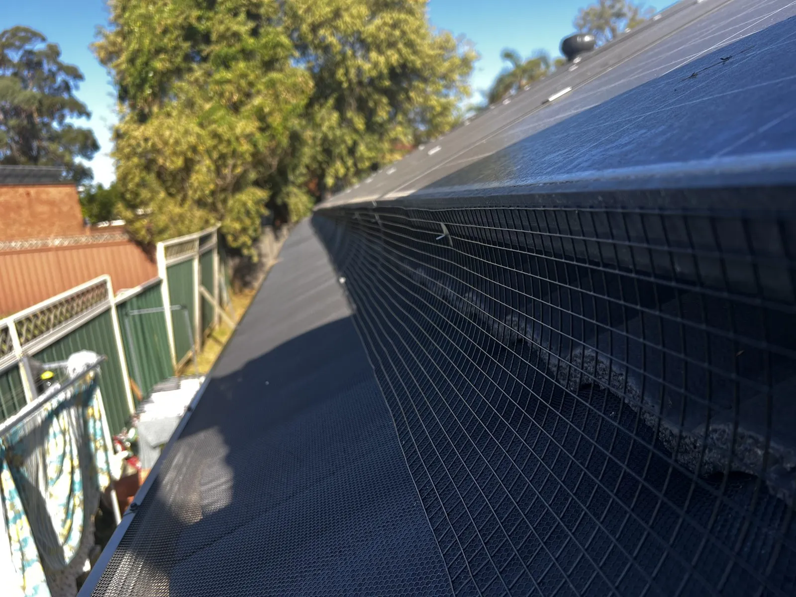 Solar bird-proofing mesh fitted along the panel edge