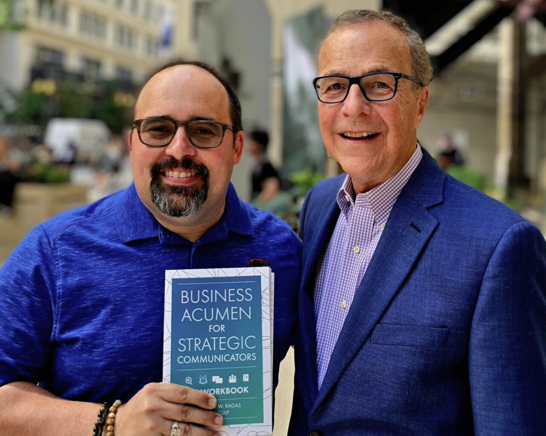 Dr. Matt Ragas and Ron Culp holding their new book Business Acumen for Strategic Communicators