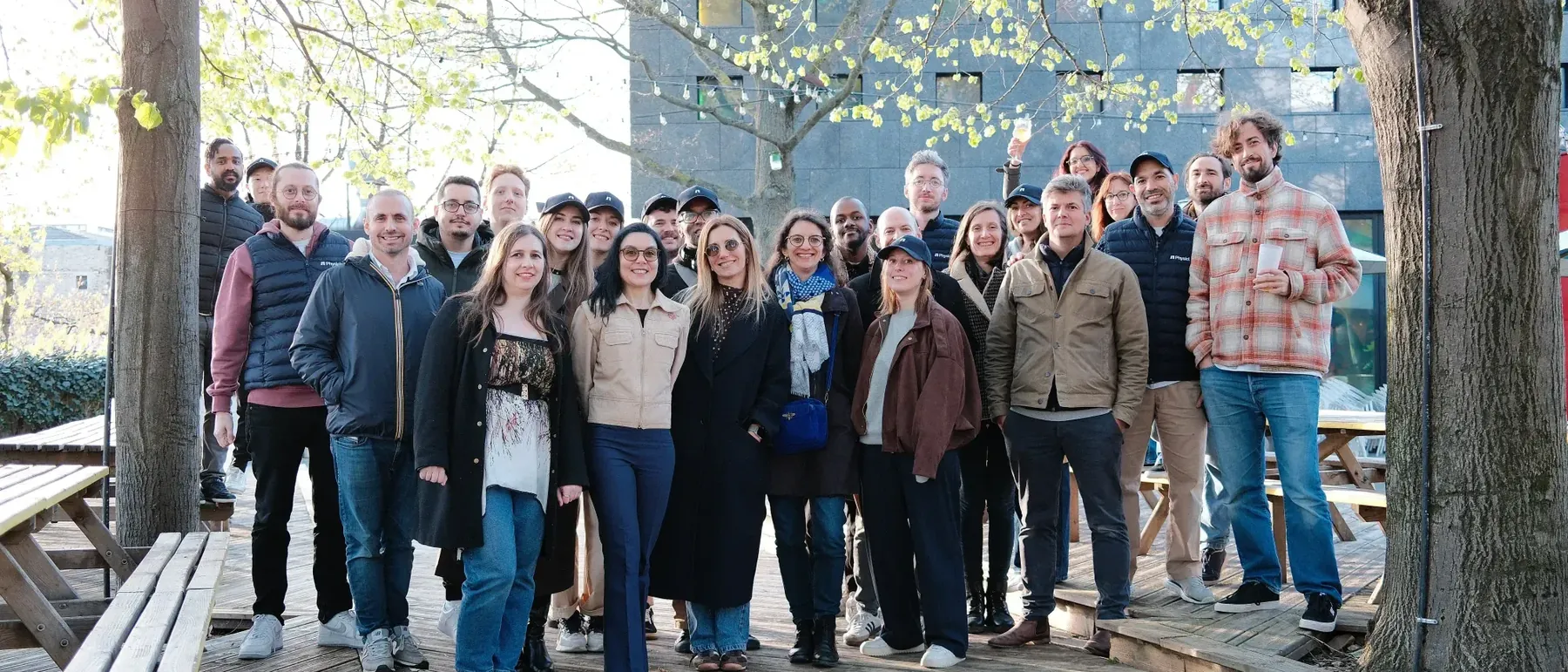 The Physicl team, around thirty people, photographed together outdoors