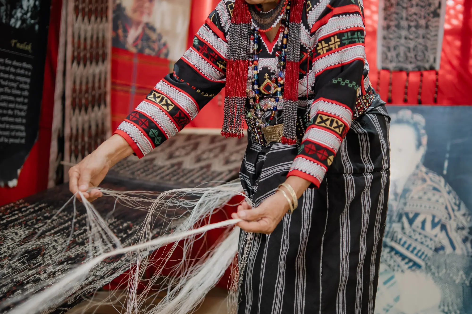 A weaver hanging and stringing abaca fibre