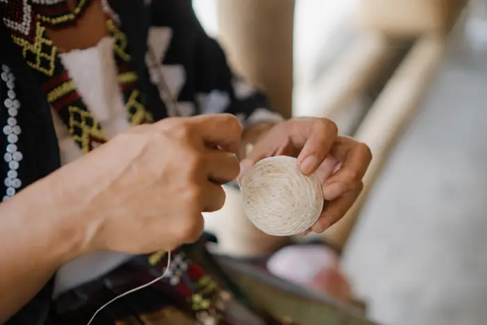 Hands winding the ball thread