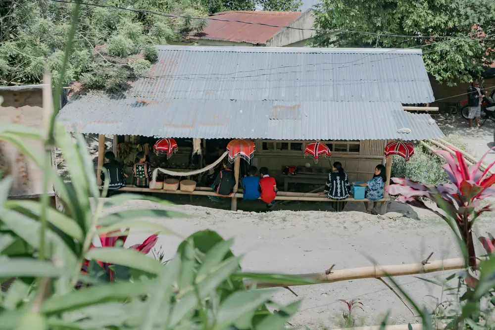 The Lang Dulay Weaving Center, a long open building among trees