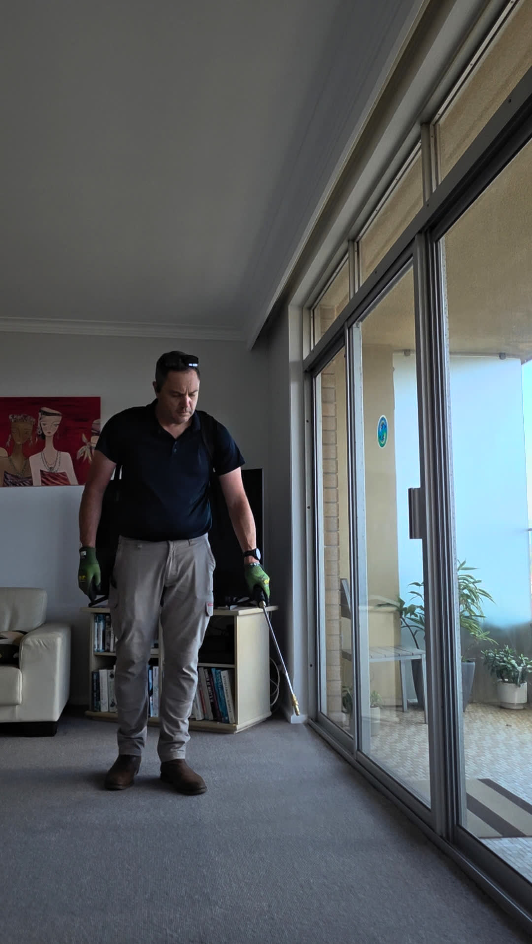 Apex technician treating an apartment balcony sliding door for strata pest control