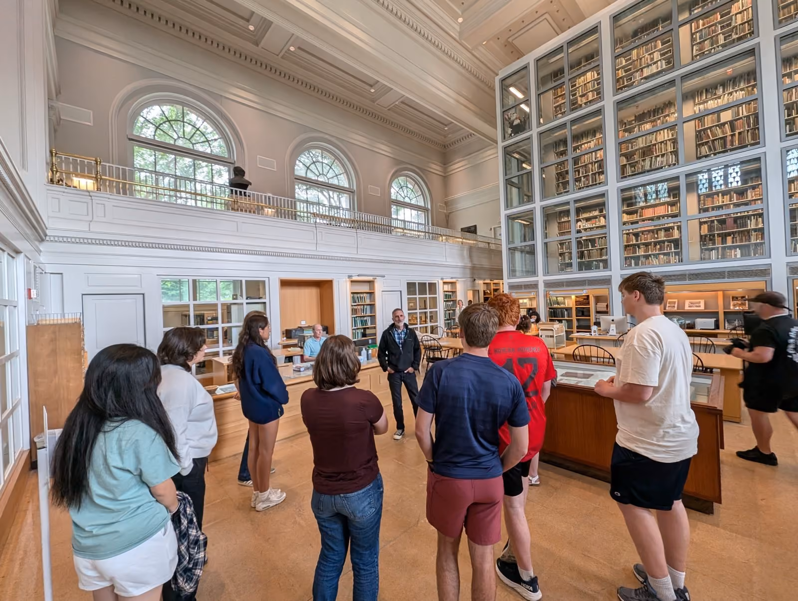 Precollege students on a tour of a Dartmouth library reading room
