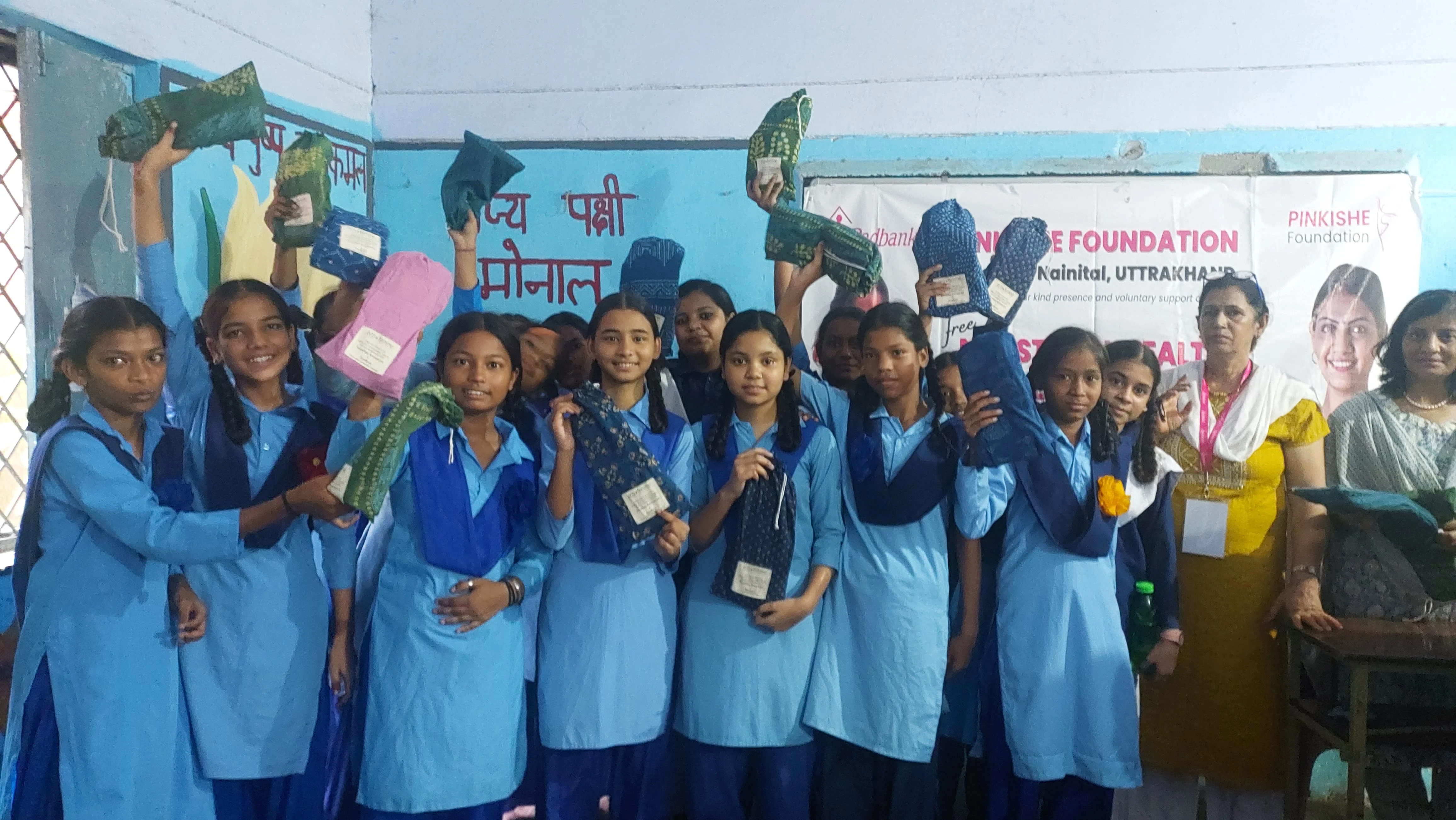 Girls embracing their menstrual health education with smiles, empowered by Pinkishe Foundation's initiatives.