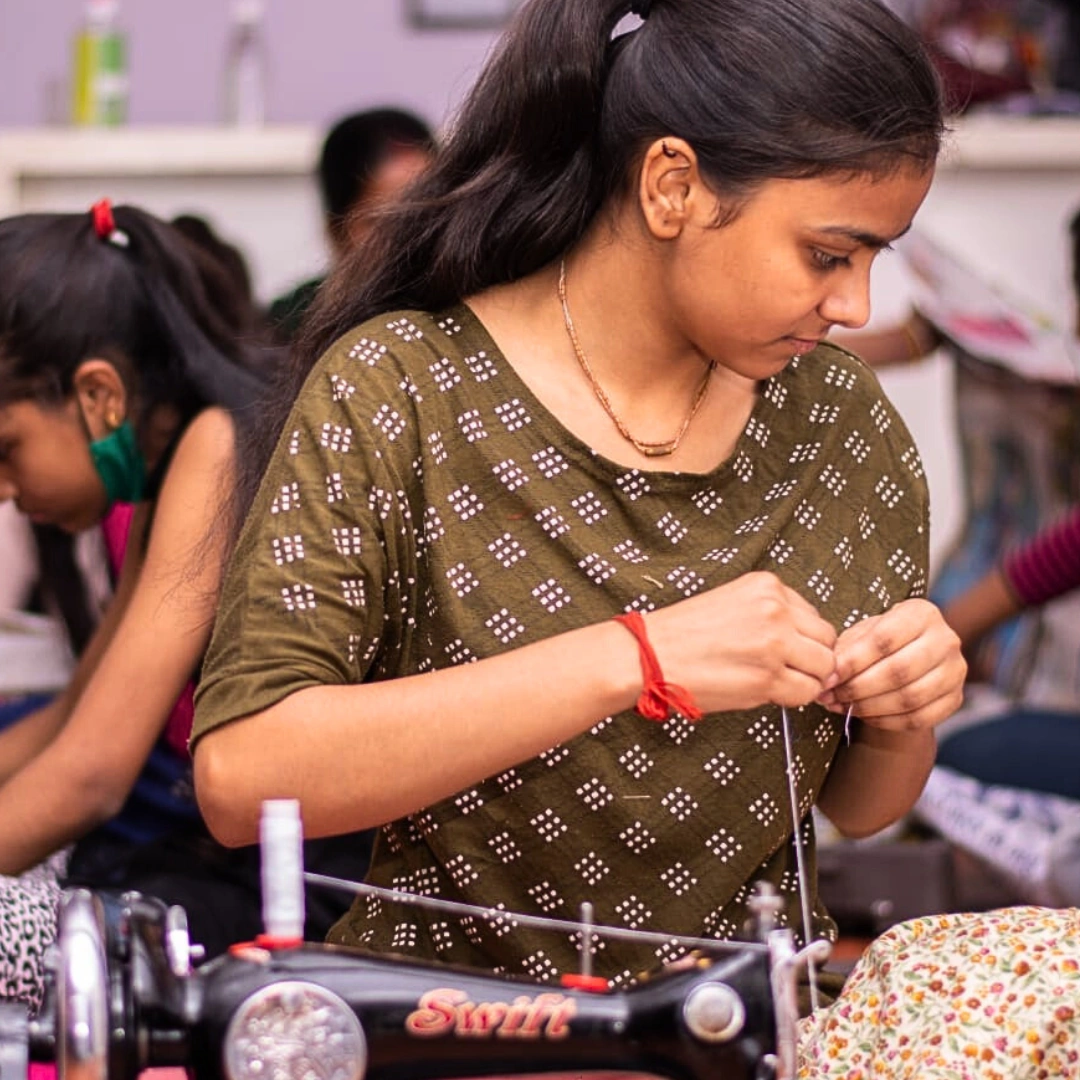 Savita learns tailoring at Pinkishe’s Praveena Center, transforming her life and supporting her family.