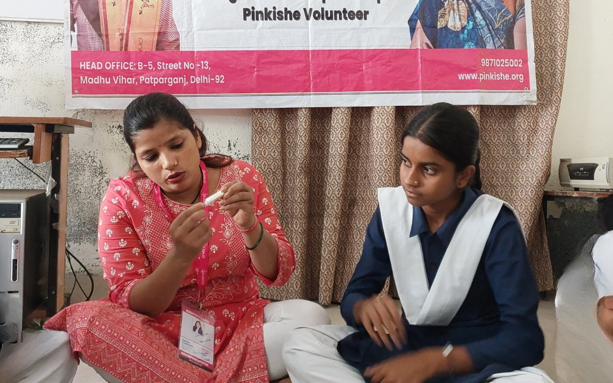 Upasana leading a Menstrual Hygiene Literacy session at Government Girls Inter College, with students receiving education about menstrual health and hygiene.