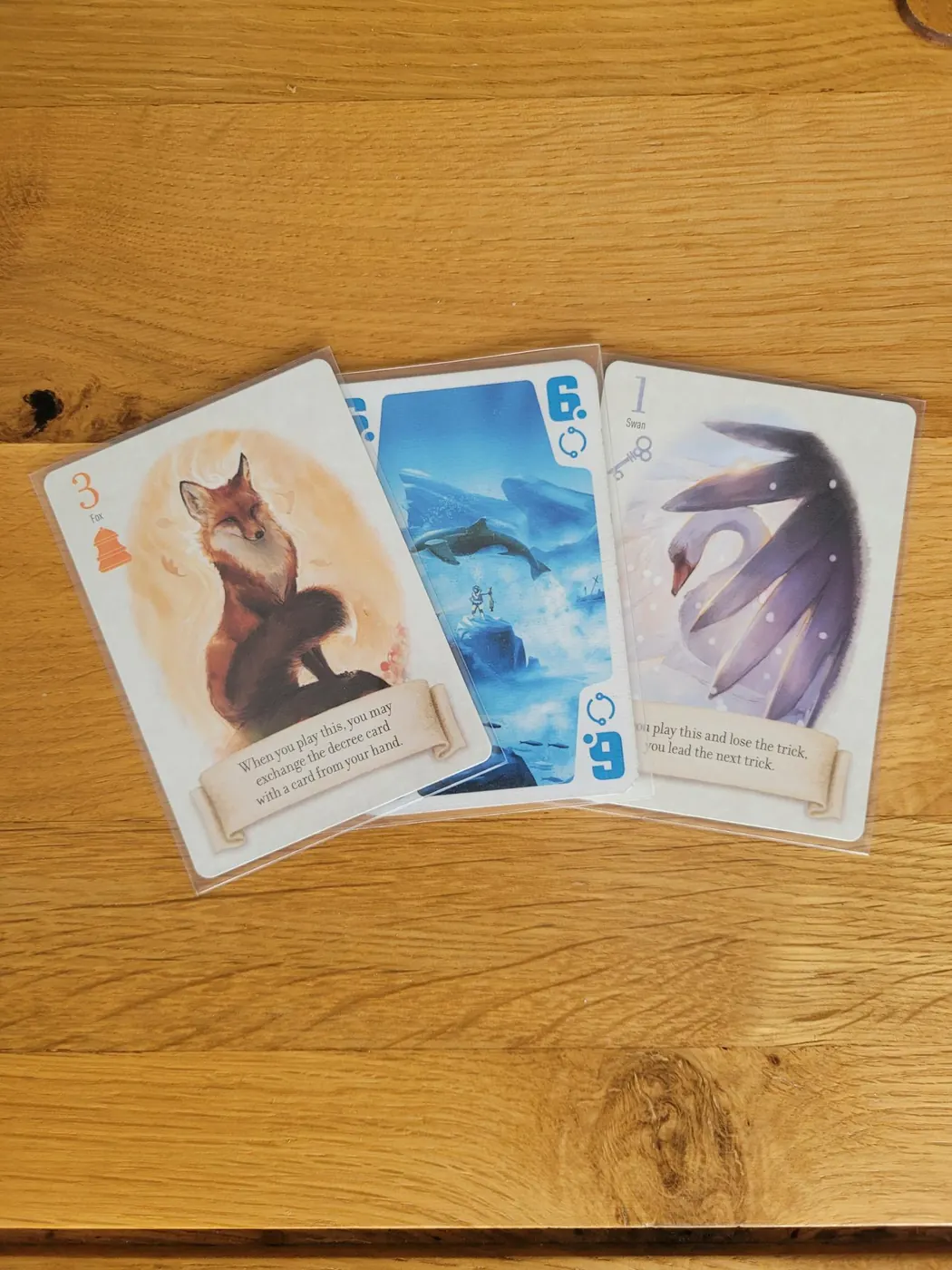 Game cards fanned out in clear Gamegenic Prime card sleeves