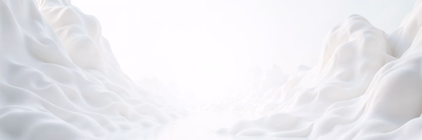A soft, fluffy white foam texture forming peaks and valleys under bright light, resembling snow or clouds.
