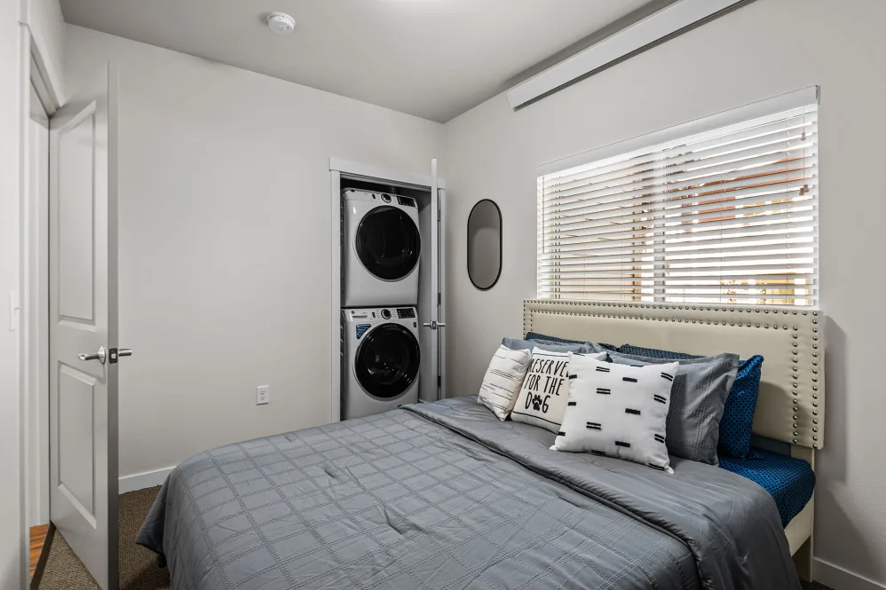 Washer and dryer in closet of bedroom