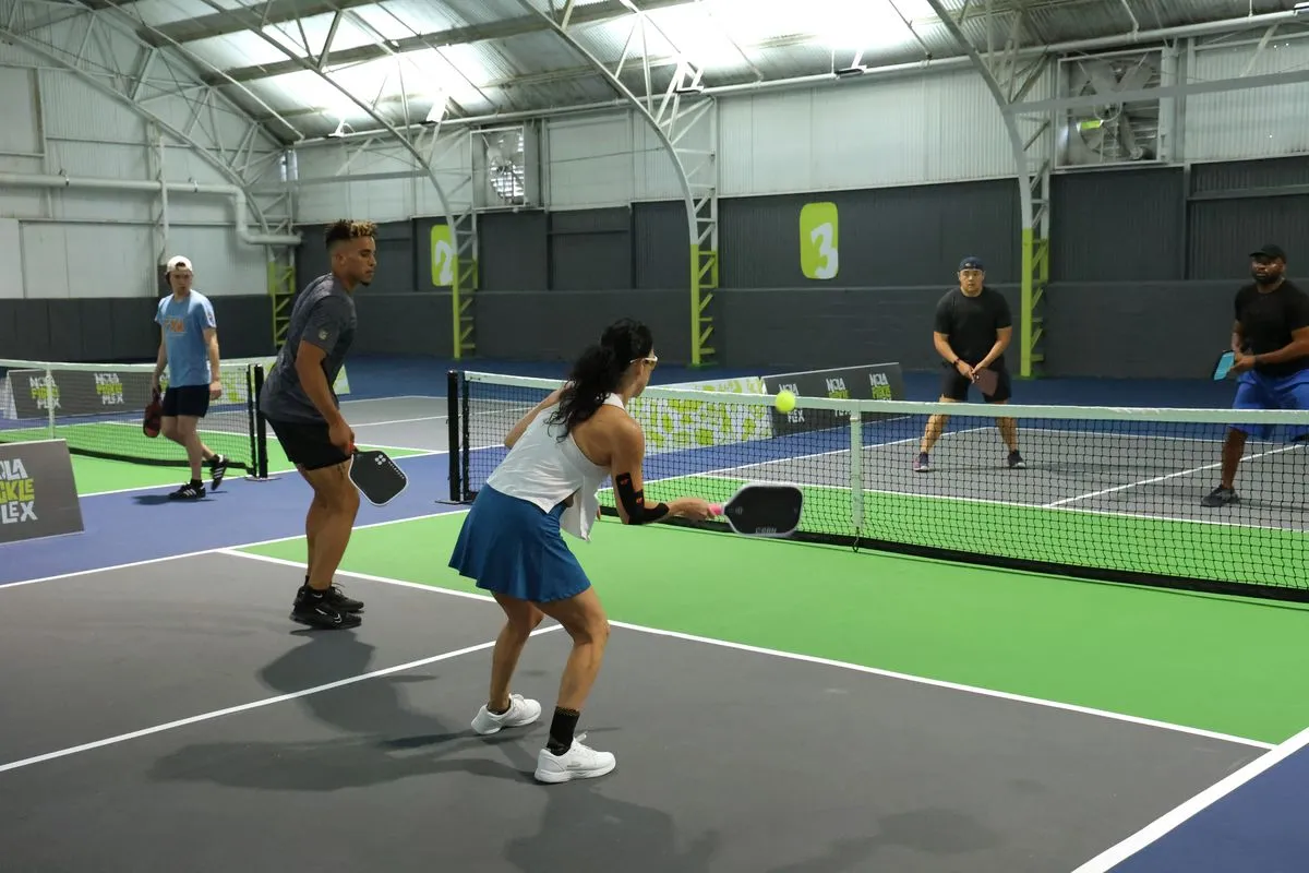 Players practicing shots during a pickleball clinic at NOLA PicklePlex