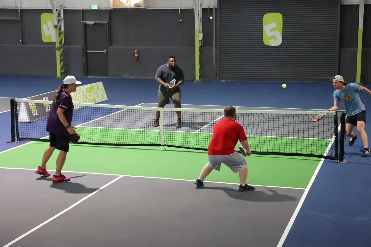Doubles teams competing in a pickleball league match at NOLA PicklePlex