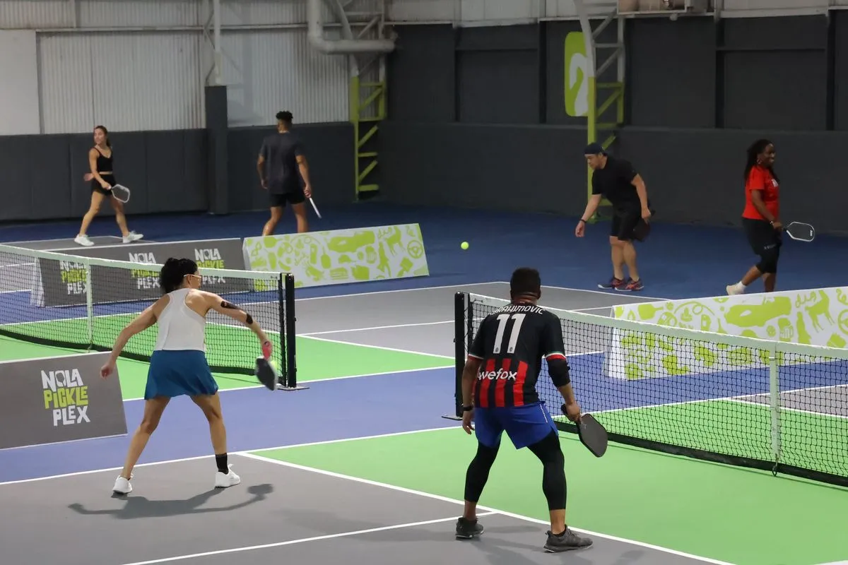 Fast doubles rally during a Live Ball session on the indoor courts at NOLA PicklePlex