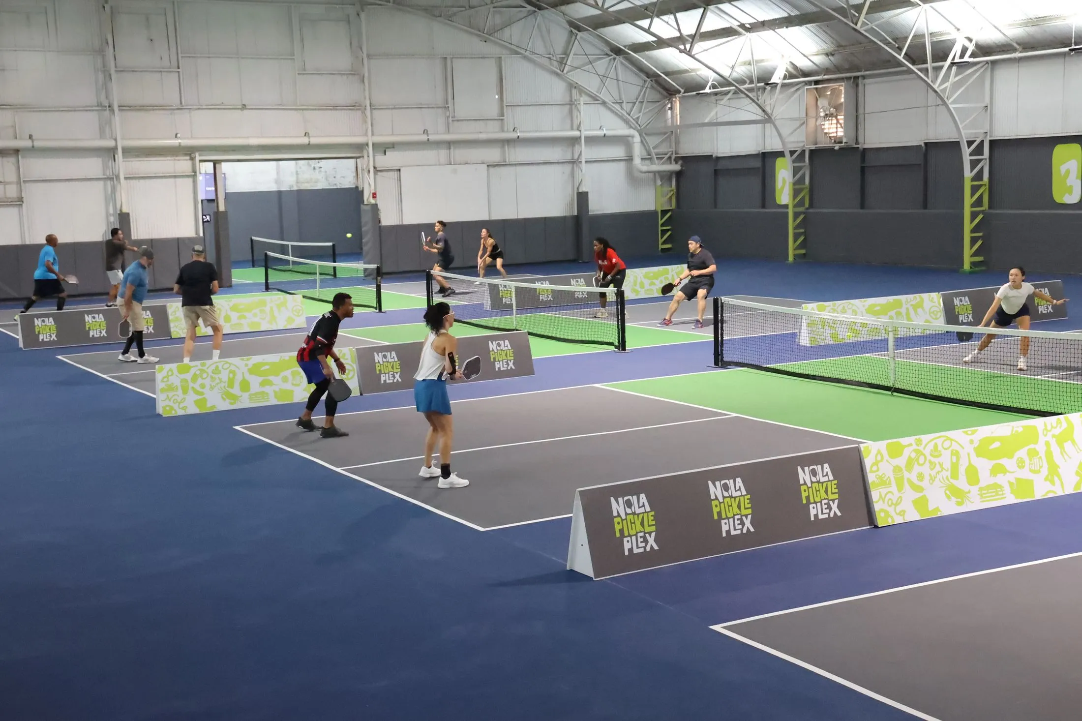 Doubles games on the indoor pickleball courts at NOLA PicklePlex in New Orleans