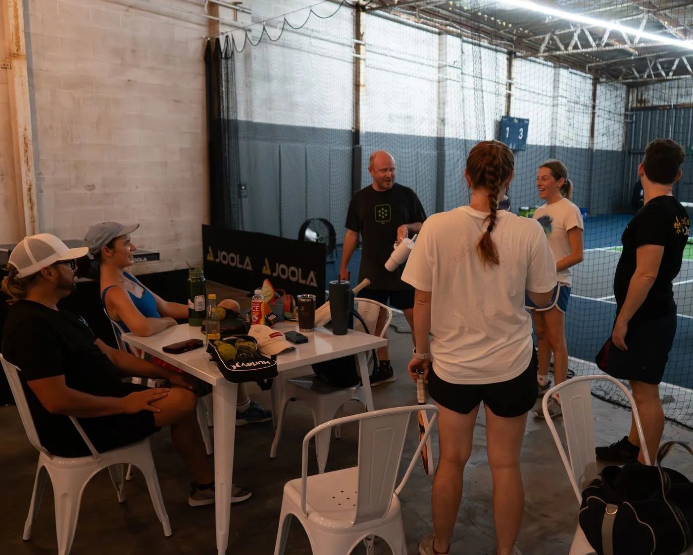 Players relaxing in the lounge between pickleball games at NOLA PicklePlex