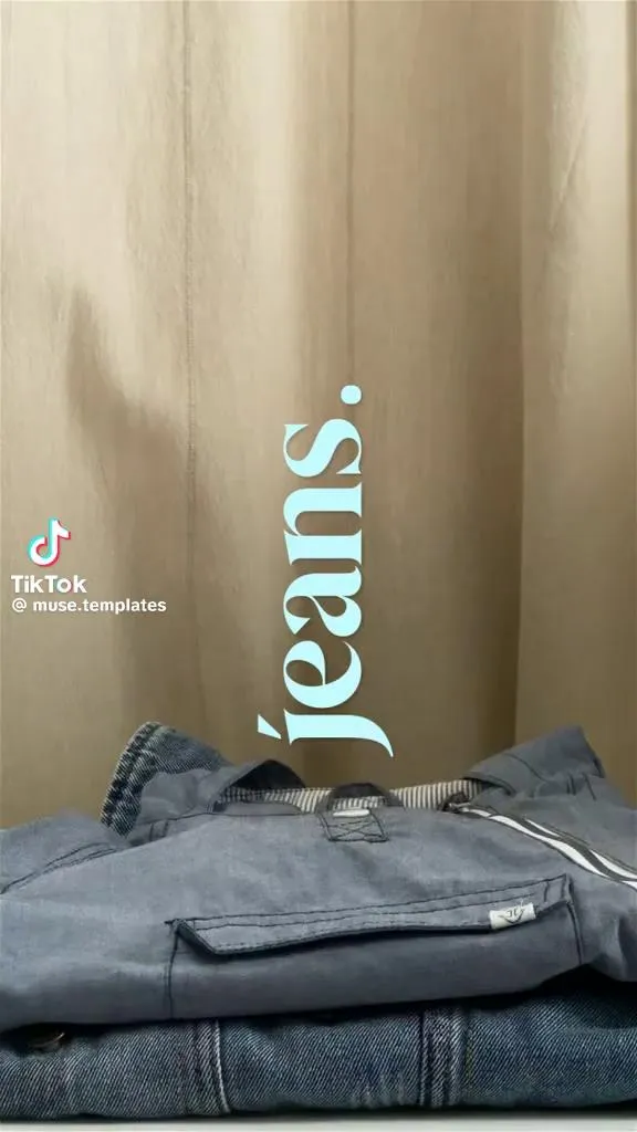 Folded jeans on a beige backdrop with the word "jeans" in serif type