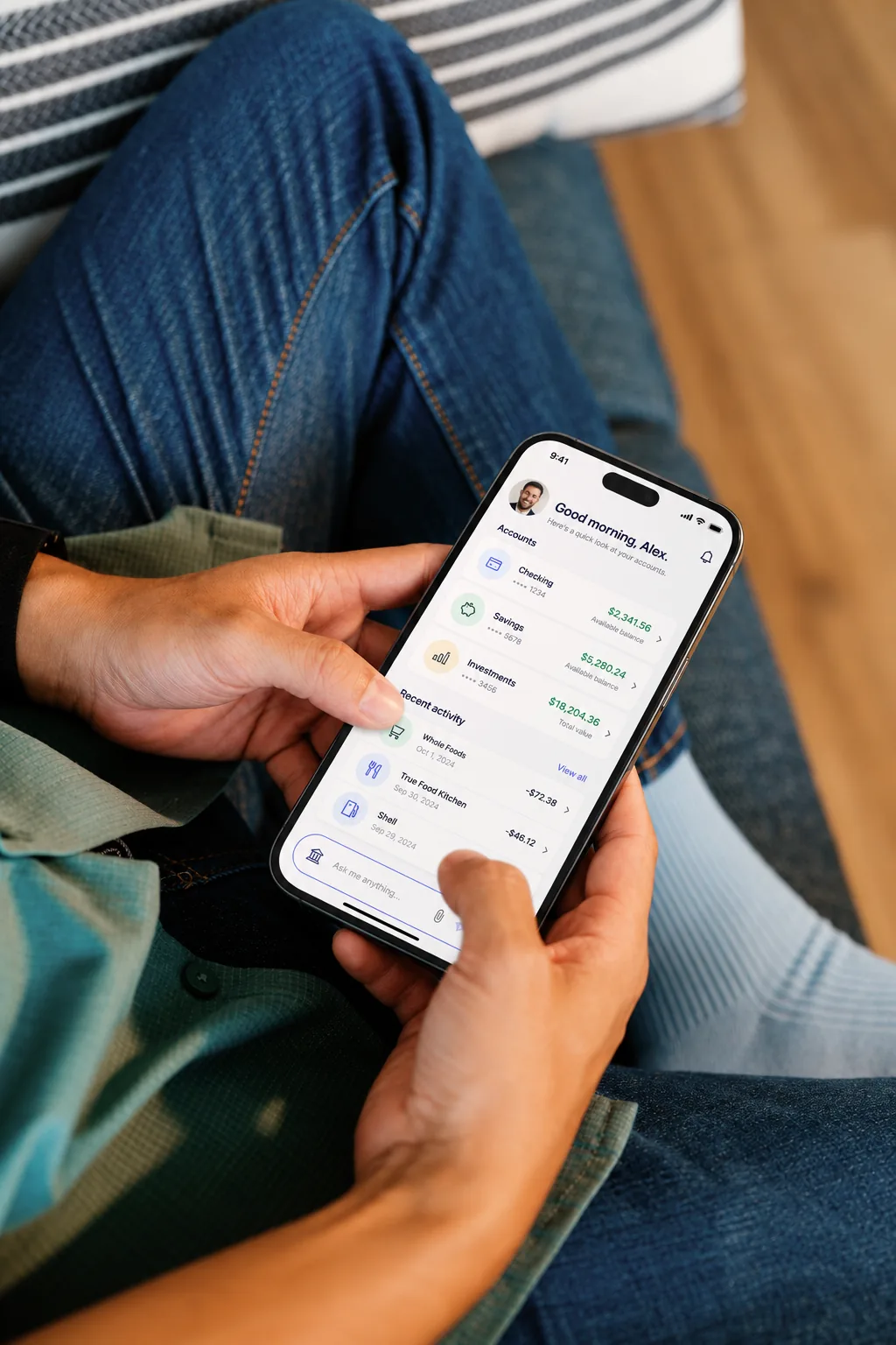 A person checking account balances and recent activity in a mobile banking app