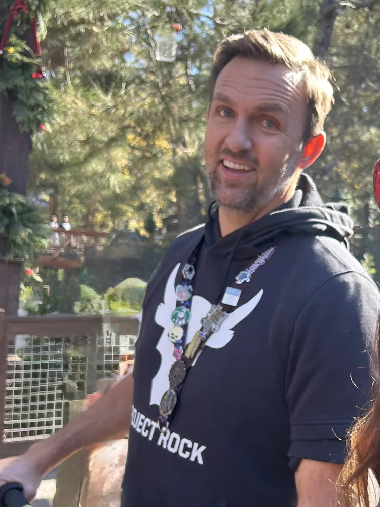 Paul in the park wearing his pin lanyard