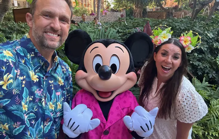 Paul and his wife with Mickey