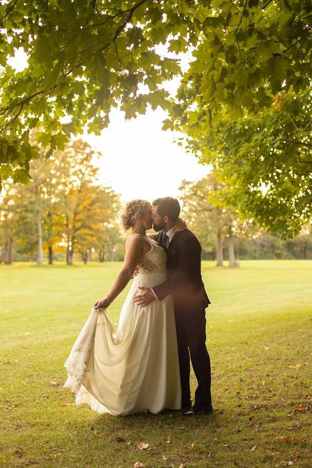 Newlyweds at golden hour under the trees on the course