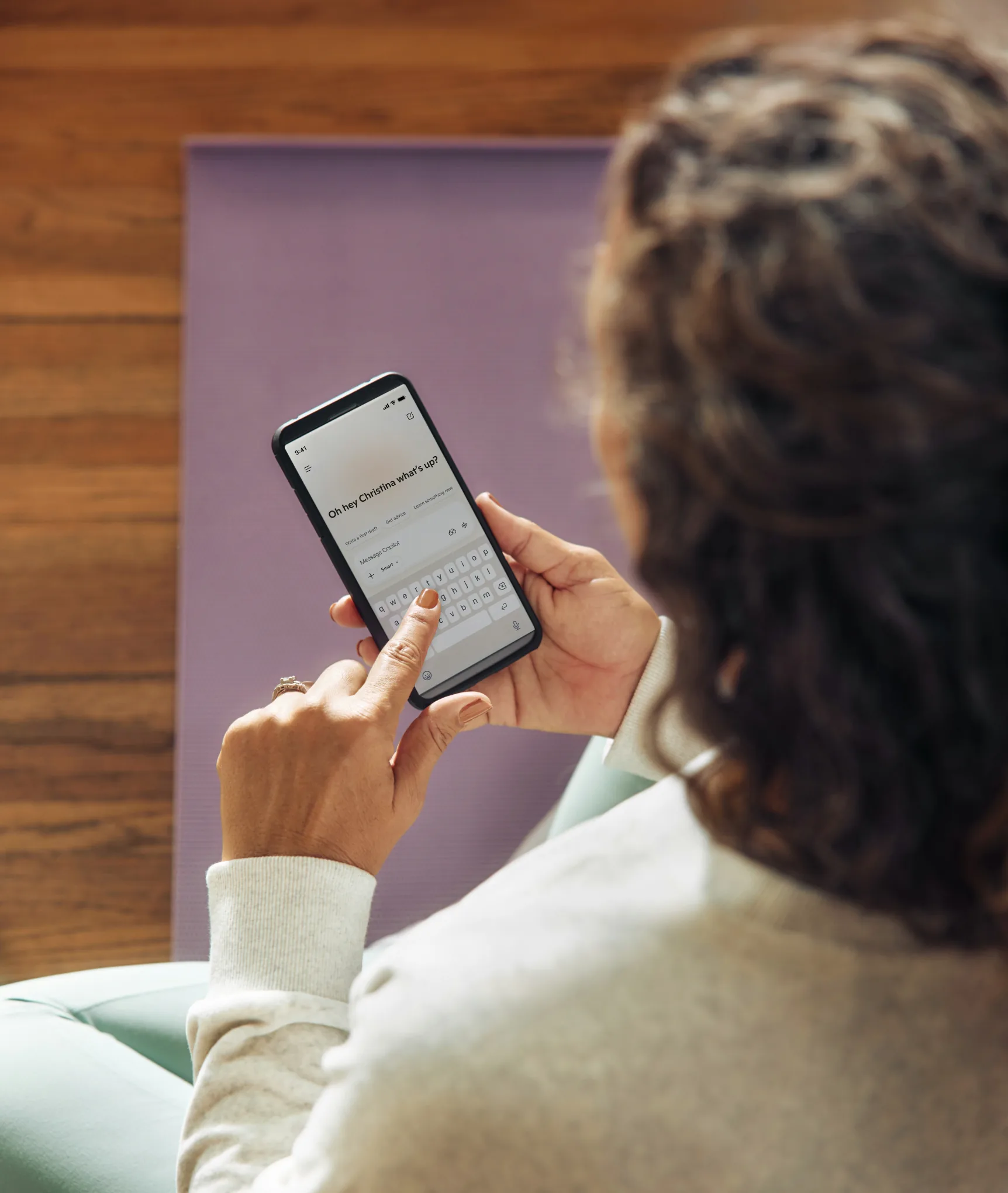 A member checking an account on a smartphone while sitting in a lounge chair