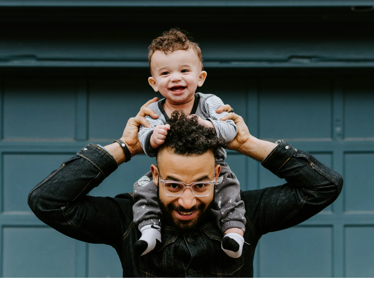 A father carrying his young son on his shoulders