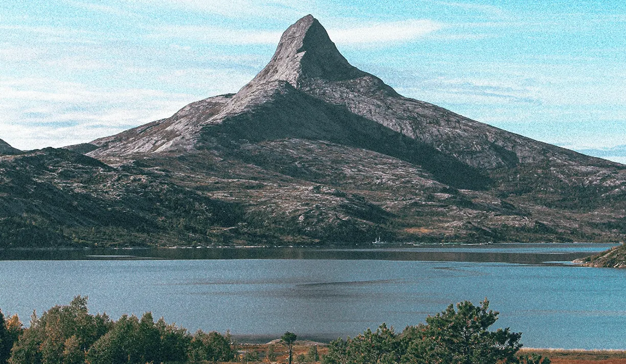 Pointed mountain above a calm lake