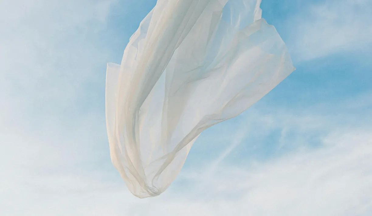 Light fabric floating against a blue sky