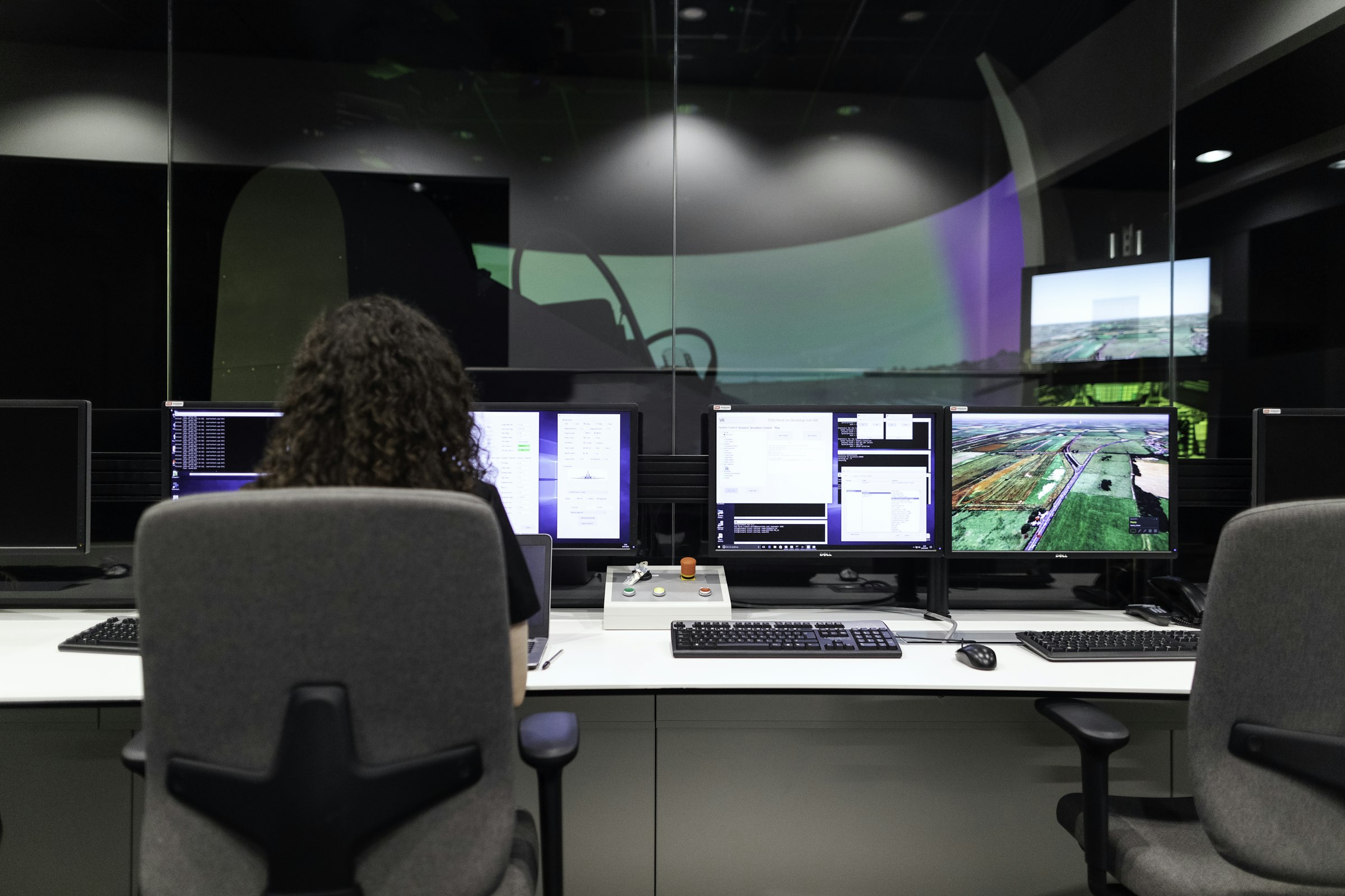 An operations centre with workstations and wall-mounted monitoring screens.
