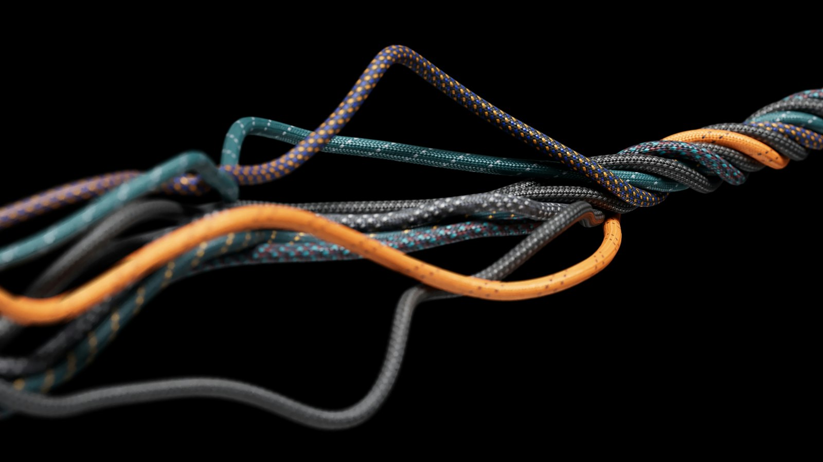 Abstract intertwined grey and orange cables.
