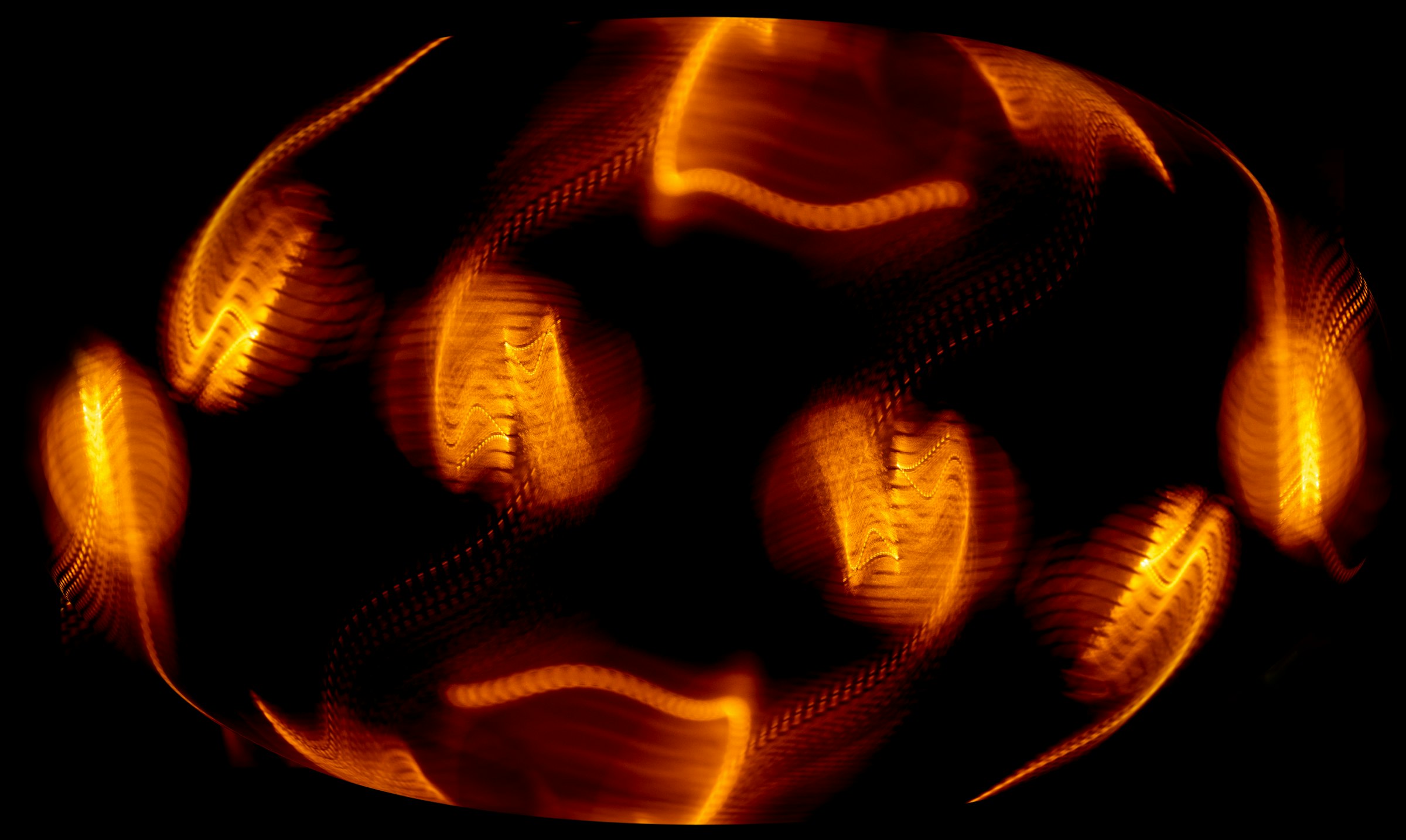 Abstract glowing orange forms arranged in a ring.