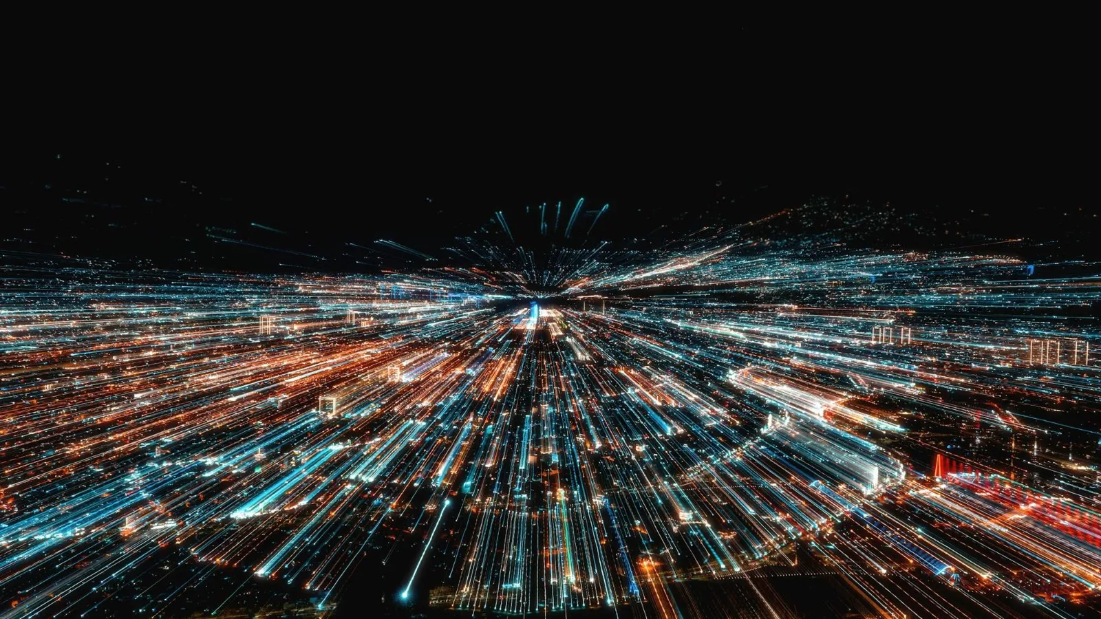 Long-exposure light trails streaming across a city at night.