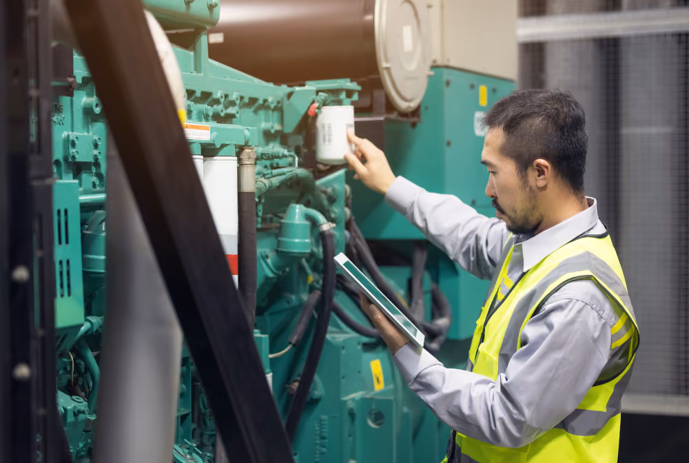 A technician working on production equipment in a clean, modern plant