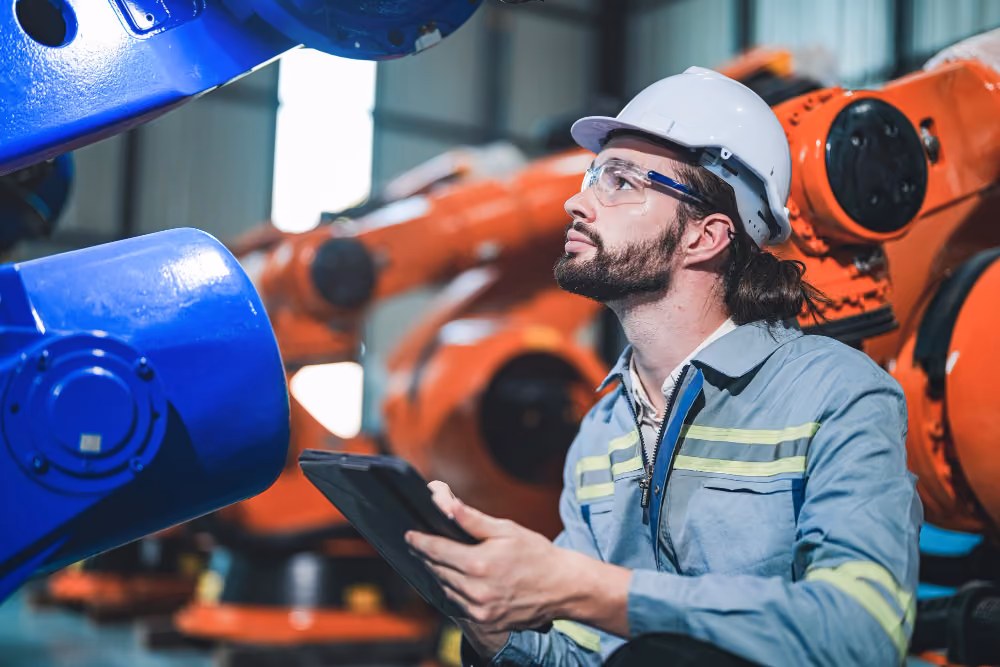 A maintenance technician checking readings at a plant workstation