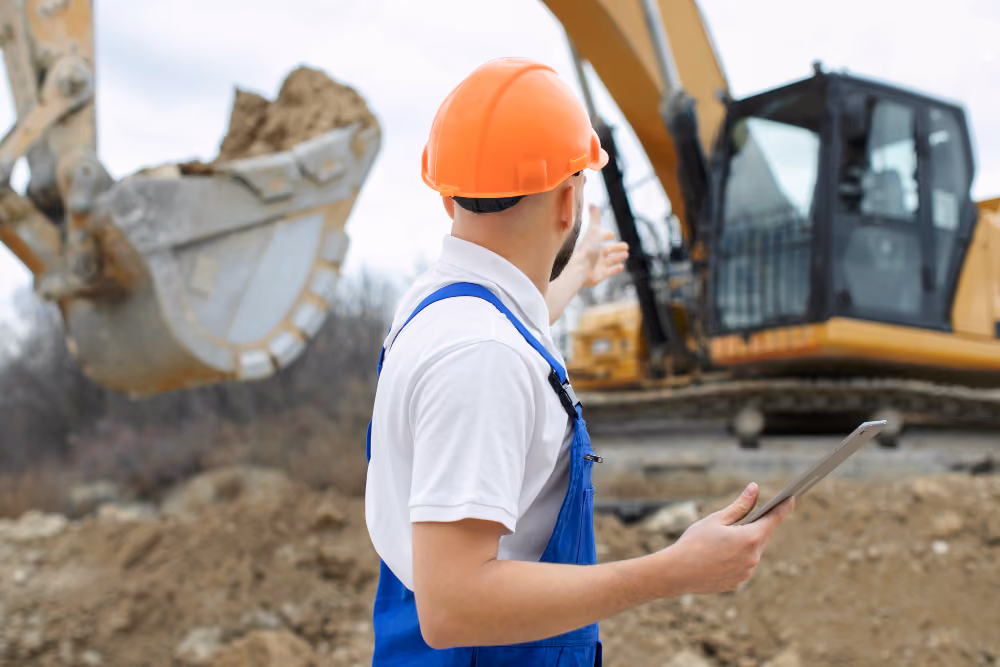 A maintenance technician checking readings at a plant workstation