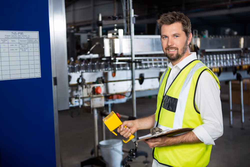 A young technician smiling on the plant floor