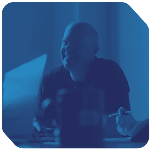 a man smiling at a computer