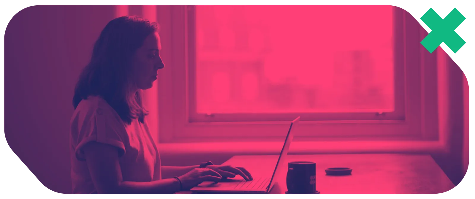 a woman sitting at a desk using a laptop