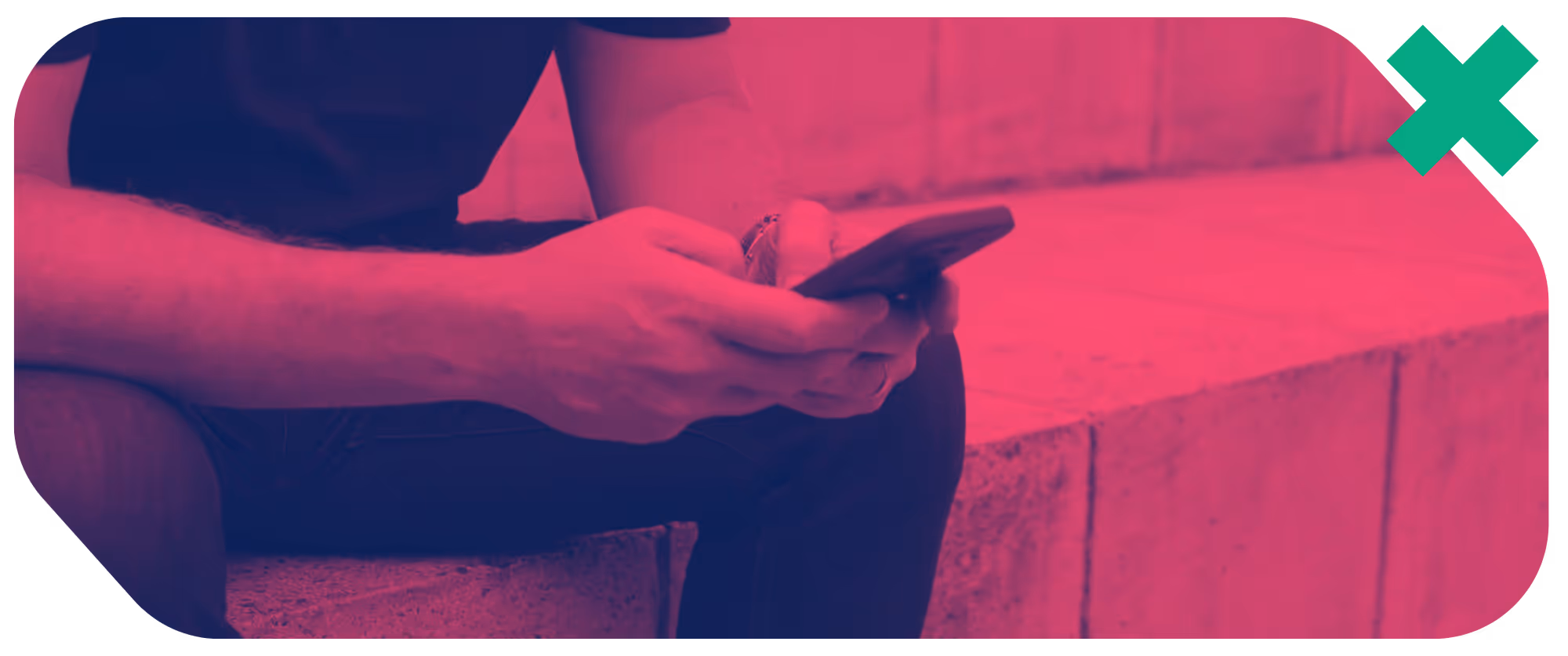 a person sitting on a ledge holding a phone