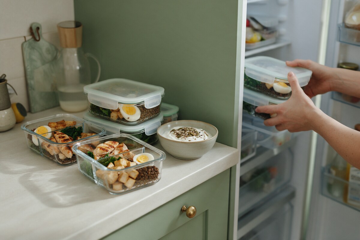Meal-prep containers with protein-rich meals going into the fridge