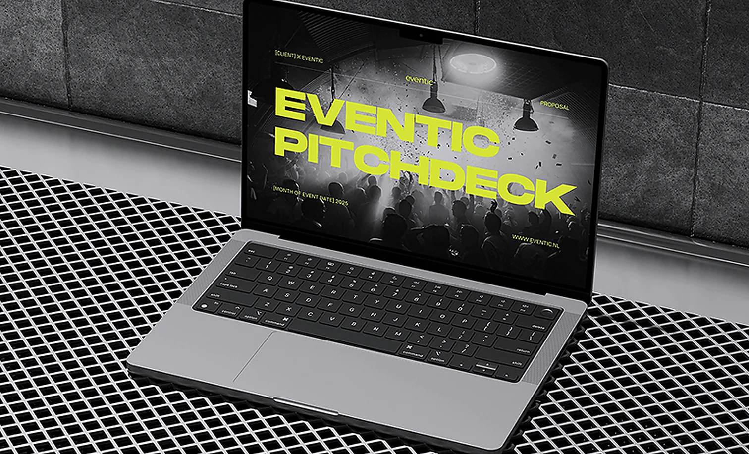 A pitch deck open on a laptop on an industrial metal floor