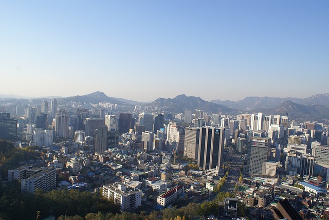 Seoul skyline with high-rise buildings and mountains behind the city