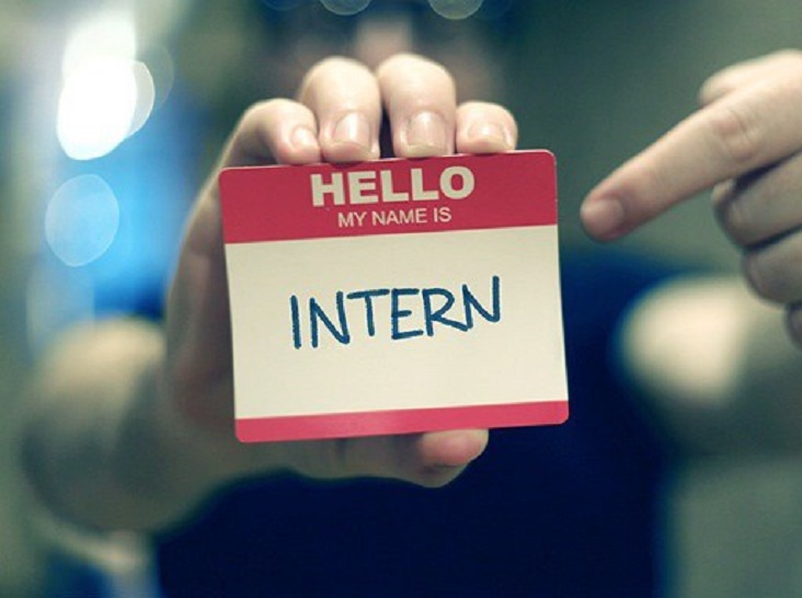 Name tag reading Hello my name is Intern held up in a workplace
