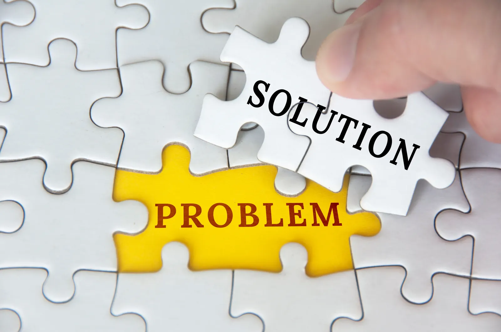 Jigsaw puzzle piece spelling out solution to a problem