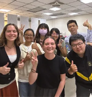 Interns giving a thumbs up in an office